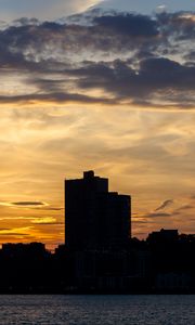 Preview wallpaper building, silhouette, sea, sunset, sky