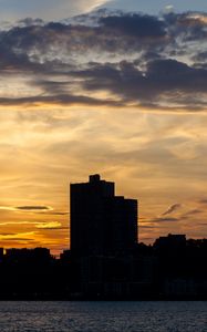 Preview wallpaper building, silhouette, sea, sunset, sky
