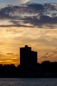 Preview wallpaper building, silhouette, sea, sunset, sky