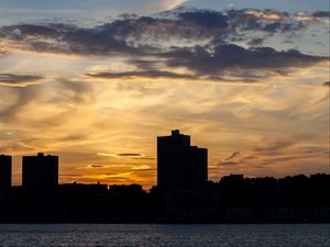Preview wallpaper building, silhouette, sea, sunset, sky