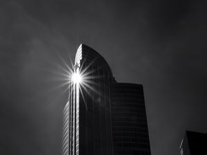 Preview wallpaper building, skyscraper, glare, rays, bw