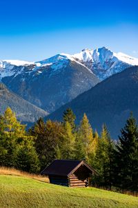 Preview wallpaper building, slope, trees, mountains, snow, nature