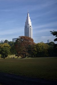 Preview wallpaper building, spire, lawn, park, trees, architecture