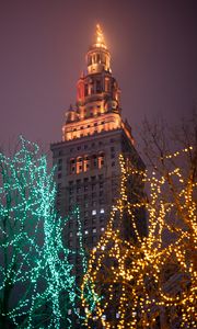 Preview wallpaper building, tower, architecture, trees, garlands, dark