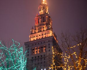 Preview wallpaper building, tower, architecture, trees, garlands, dark