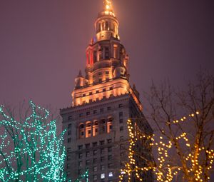 Preview wallpaper building, tower, architecture, trees, garlands, dark