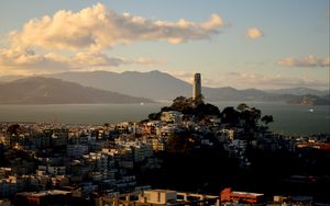 Preview wallpaper building, tower, city, mountains, sea