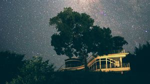 Preview wallpaper building, tree, starry sky, stars, night