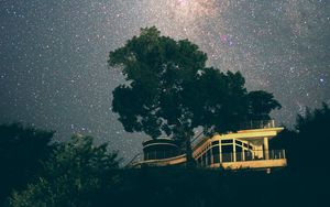 Preview wallpaper building, tree, starry sky, stars, night