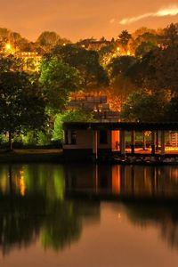 Preview wallpaper building, trees, landscape, night, lights, river