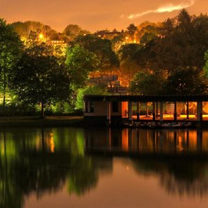 Preview wallpaper building, trees, landscape, night, lights, river