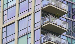 Preview wallpaper building, windows, balconies, flowers, plants