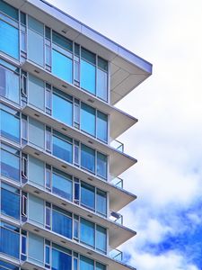 Preview wallpaper building, windows, glass, balconies, clouds, sky, blue