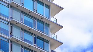 Preview wallpaper building, windows, glass, balconies, clouds, sky, blue