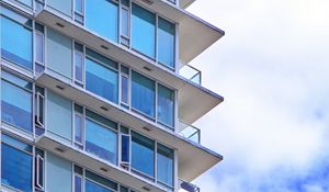 Preview wallpaper building, windows, glass, balconies, clouds, sky, blue