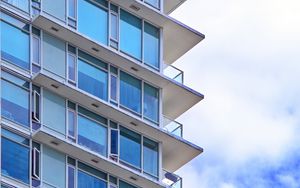 Preview wallpaper building, windows, glass, balconies, clouds, sky, blue
