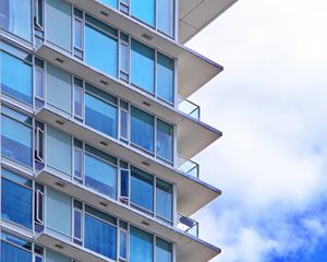 Preview wallpaper building, windows, glass, balconies, clouds, sky, blue