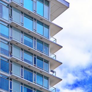 Preview wallpaper building, windows, glass, balconies, clouds, sky, blue