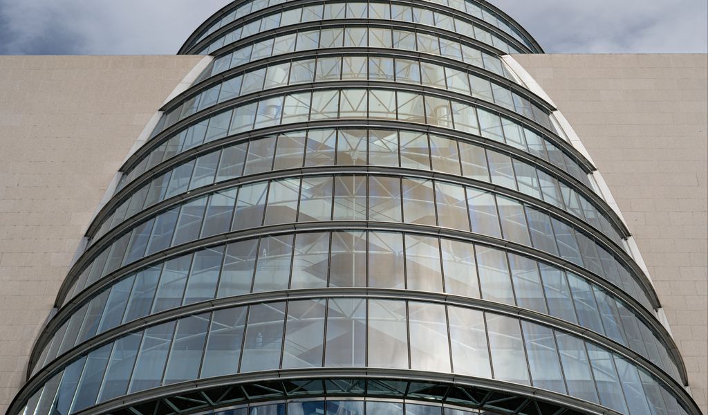 1024x600 Wallpaper building, windows, walls, clouds, city, architecture