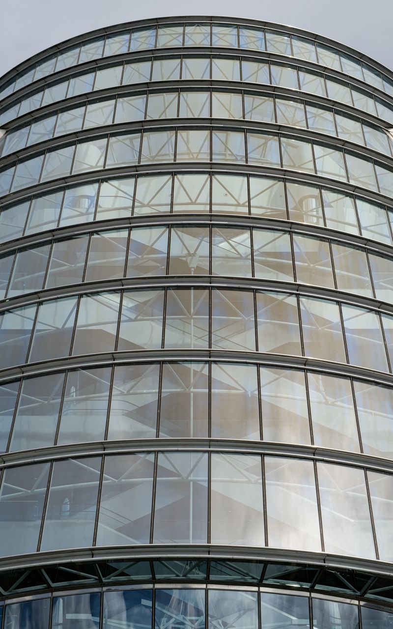 800x1280 Wallpaper building, windows, walls, clouds, city, architecture