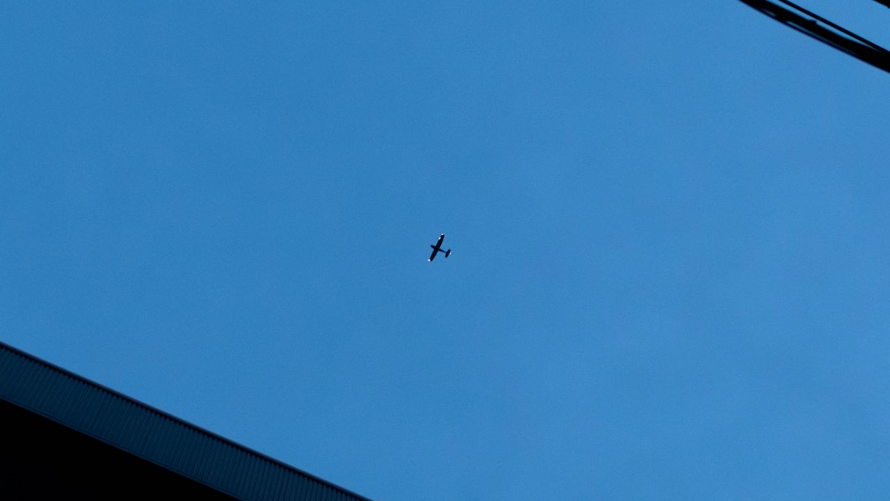 Wallpaper building, wires, airplane, sky