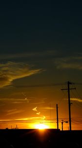 Preview wallpaper buildings, antennas, sun, sunset, clouds, sky, dark