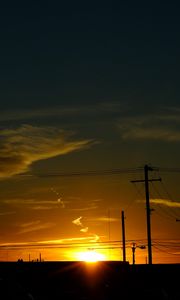 Preview wallpaper buildings, antennas, sun, sunset, clouds, sky, dark