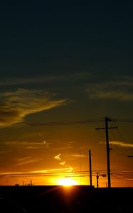 Preview wallpaper buildings, antennas, sun, sunset, clouds, sky, dark