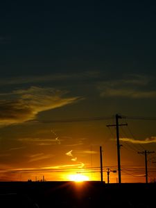 Preview wallpaper buildings, antennas, sun, sunset, clouds, sky, dark