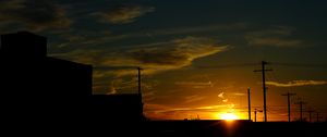 Preview wallpaper buildings, antennas, sun, sunset, clouds, sky, dark