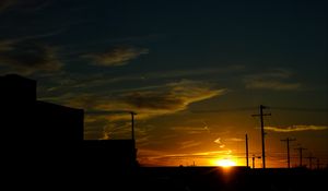 Preview wallpaper buildings, antennas, sun, sunset, clouds, sky, dark