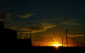 Preview wallpaper buildings, antennas, sun, sunset, clouds, sky, dark