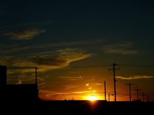 Preview wallpaper buildings, antennas, sun, sunset, clouds, sky, dark