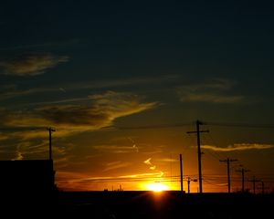 Preview wallpaper buildings, antennas, sun, sunset, clouds, sky, dark