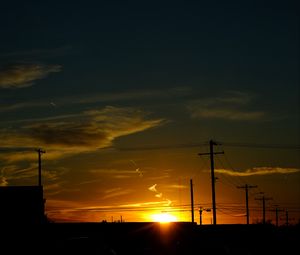 Preview wallpaper buildings, antennas, sun, sunset, clouds, sky, dark