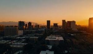 Preview wallpaper buildings, architecture, city, road, sunset, evening