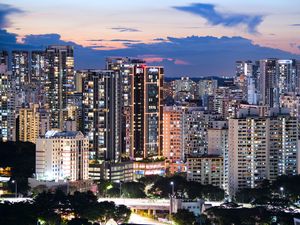 Preview wallpaper buildings, architecture, city, sunset, evening, lights