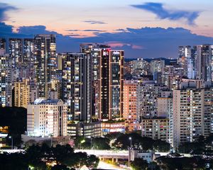 Preview wallpaper buildings, architecture, city, sunset, evening, lights