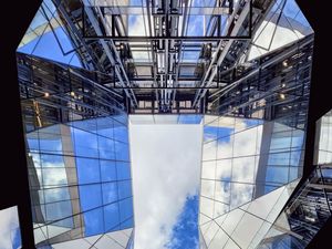 Preview wallpaper buildings, bottom view, mirror, sky, clouds, architecture