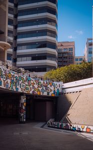 Preview wallpaper buildings, bridge, pilings, graffiti