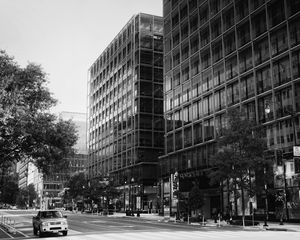 Preview wallpaper buildings, city, car, trees, street, bw