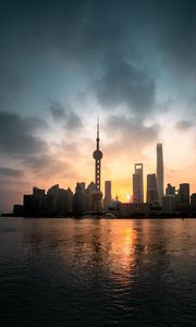 Preview wallpaper buildings, city, coast, sunset, water, architecture