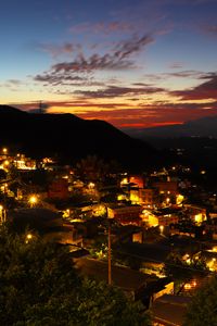 Preview wallpaper buildings, city, lights, hills, silhouettes, evening