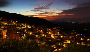 Preview wallpaper buildings, city, lights, hills, silhouettes, evening