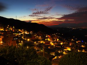 Preview wallpaper buildings, city, lights, hills, silhouettes, evening