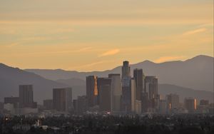 Preview wallpaper buildings, city, mountains, sunrise