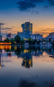 Preview wallpaper buildings, city, river, reflection, evening