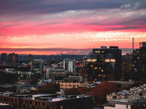 Preview wallpaper buildings, city, roofs, sunset