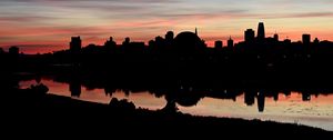 Preview wallpaper buildings, city, silhouettes, river, evening