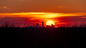 Preview wallpaper buildings, city, silhouettes, sun, sunset, dark